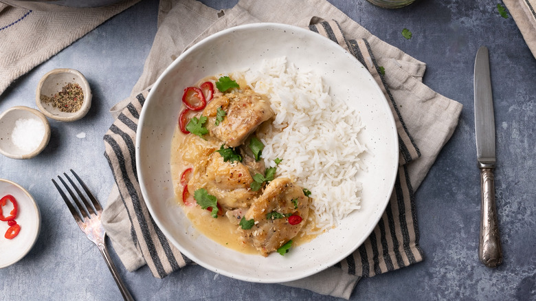 coconut lime chicken thighs with rice in bowl