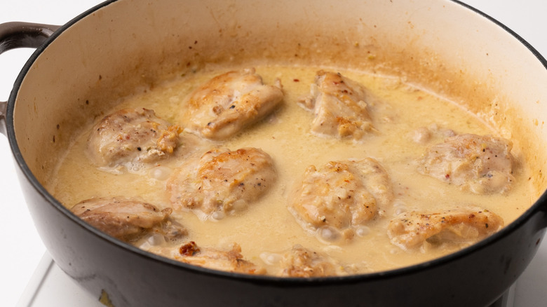 chicken simmering in coconut sauce