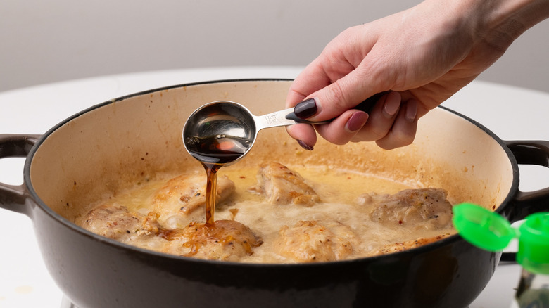 adding fish sauce to pan