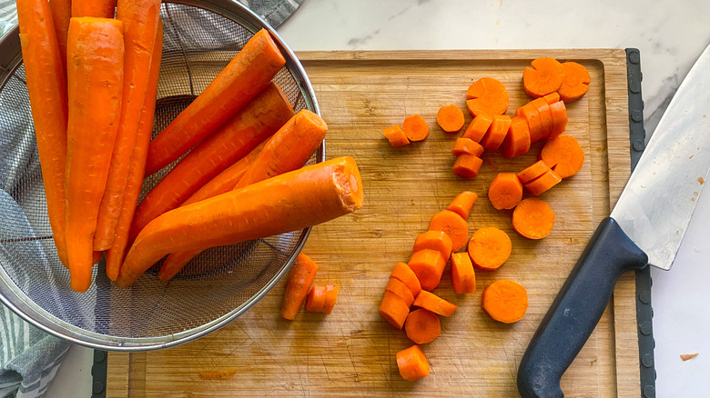 carrots being cut on board