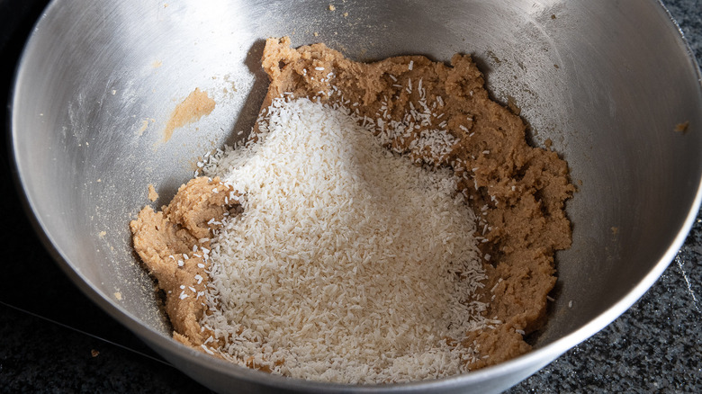 adding coconut to cookie dough