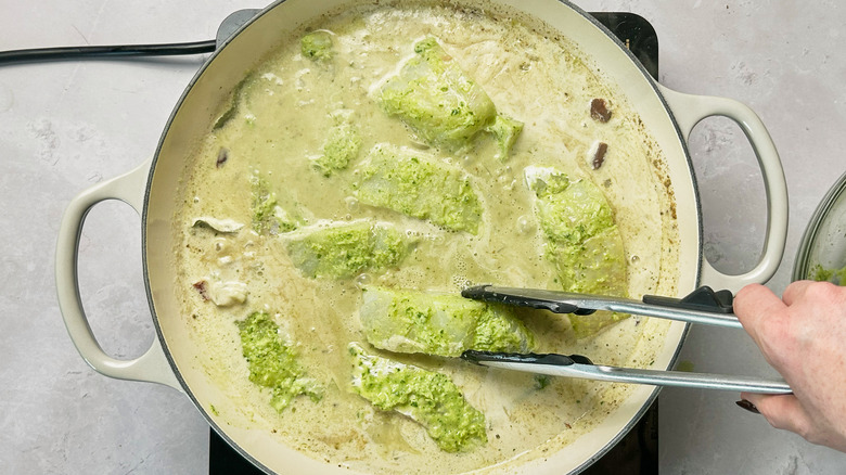 adding fish to skillet