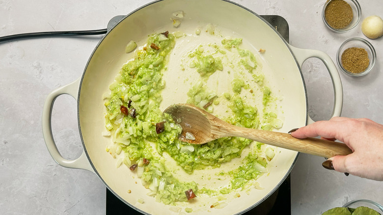 stirring curry paste into pot