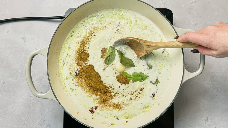 stirring coconut milk in pot