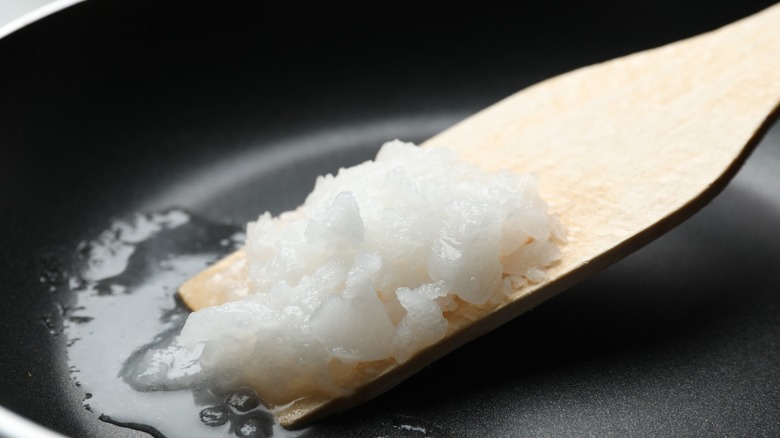 Close-up of coconut oil melting in frying pan