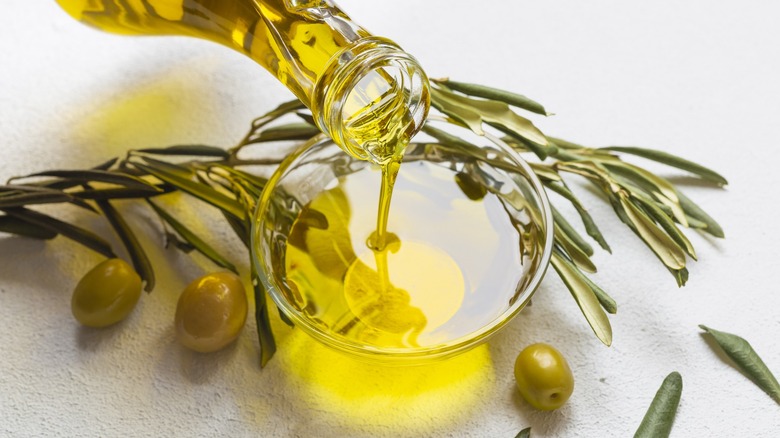 Olive oil pouring into a dish