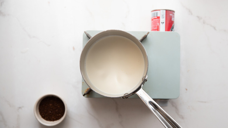 Cream simmering in sauce pot