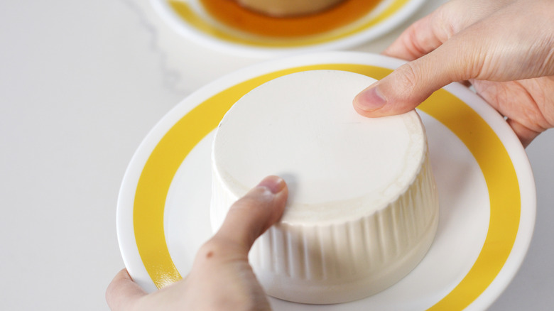 Inverting custard pudding ramekin onto a plate