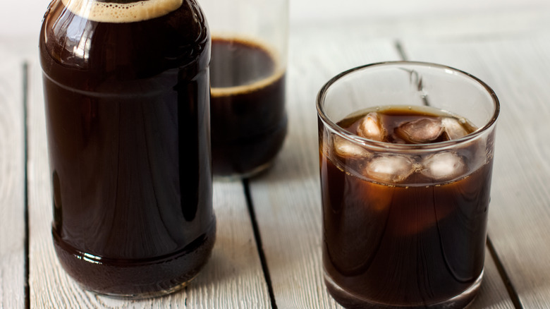 Glass and carafe of cold brew coffee