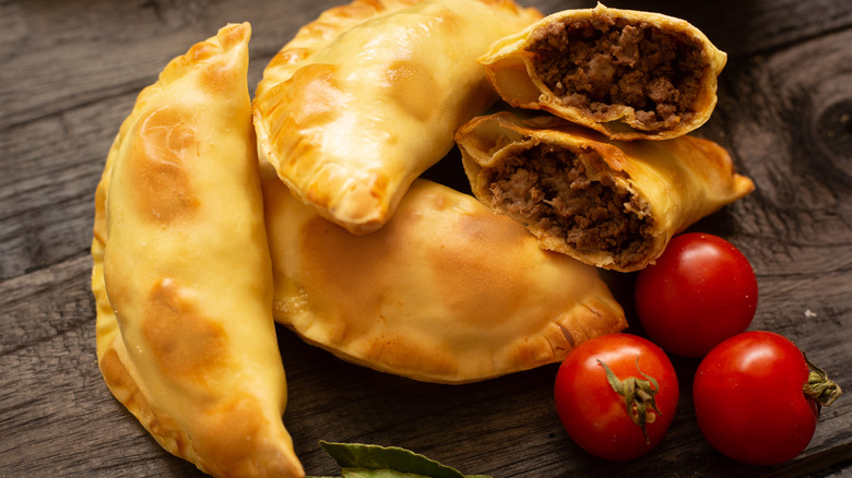 open empanada with tomatoes