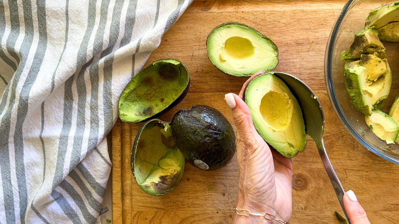 scooping out the avocado flesh