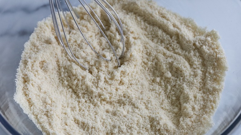 Close-up of flour and whisk in a mixing bowl