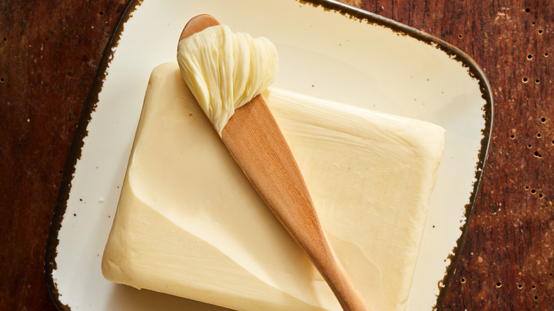 Square of butter with knife 