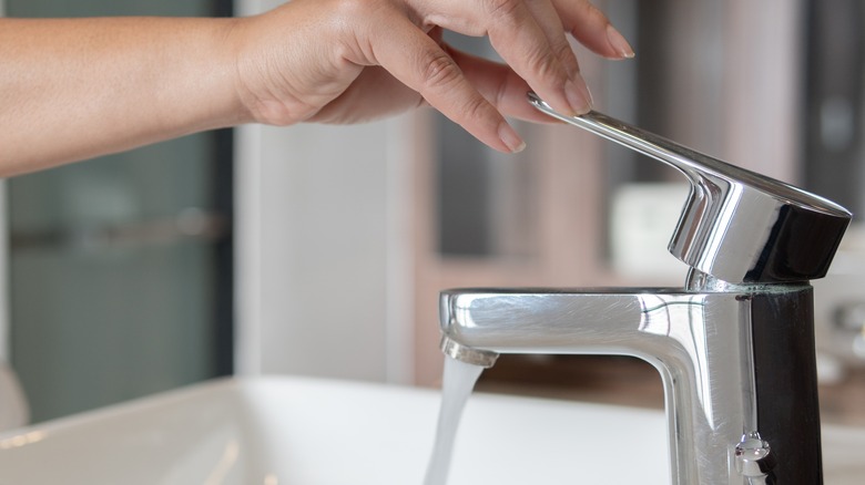  A woman running tap water 