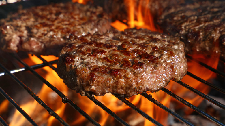 Burgers cooking on grill grate