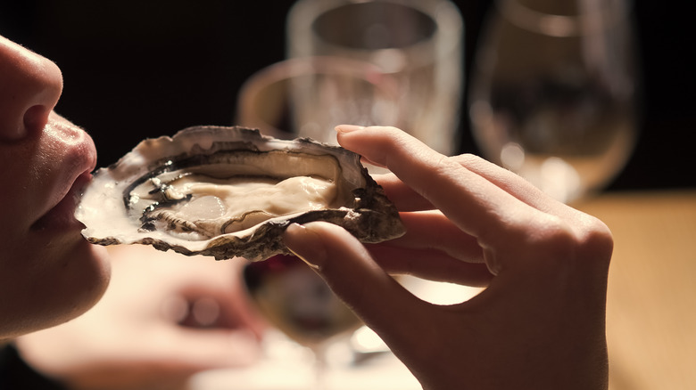 Woman eating an oyster