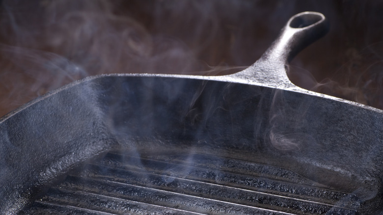 smoke coming off of a cast iron grill pan