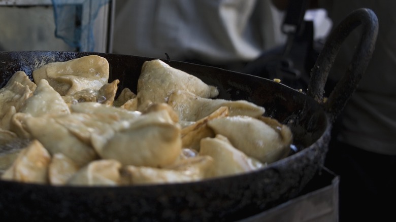 cast iron skillet overcrowded with food