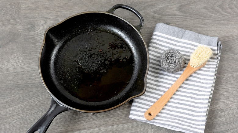 cast iron pan next to scrubbers