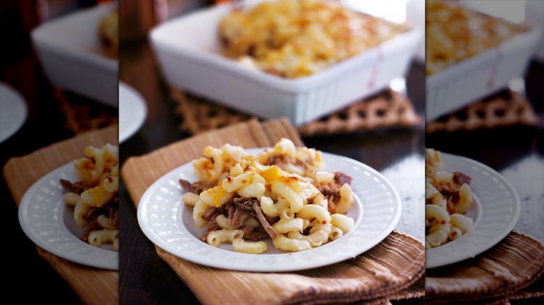 Pulled pork on mac and cheese in dish 