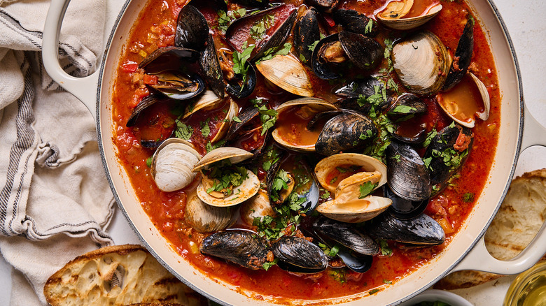 Mussels and clams with broth in Dutch oven