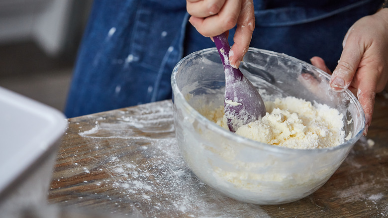 Home cook mixing cake batter with a silicone spoon