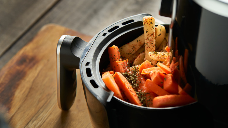 carrot batons and French fries in an air fryer