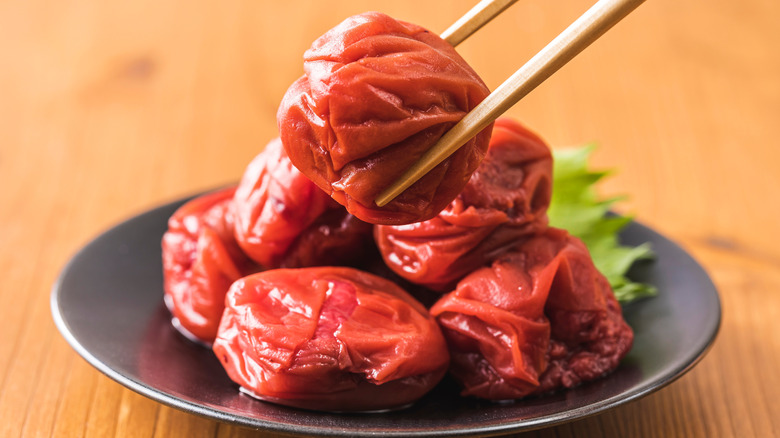 Offering an umeboshi by chopstick