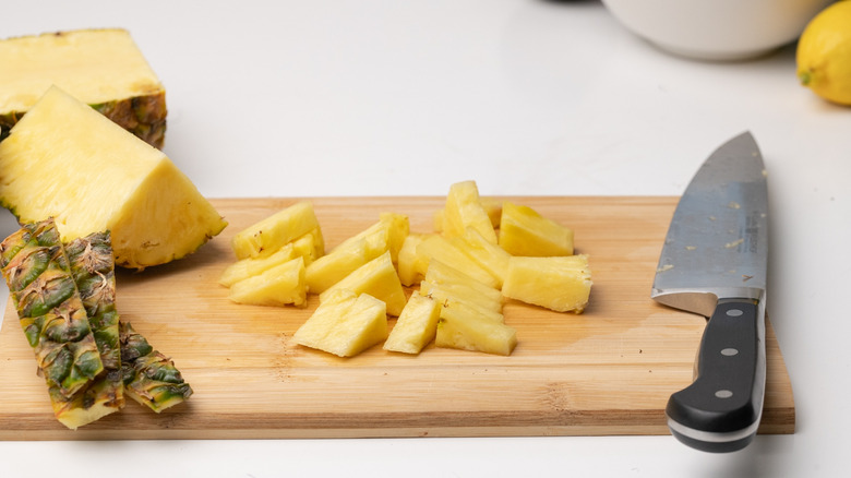 chopped pineapple on cutting board