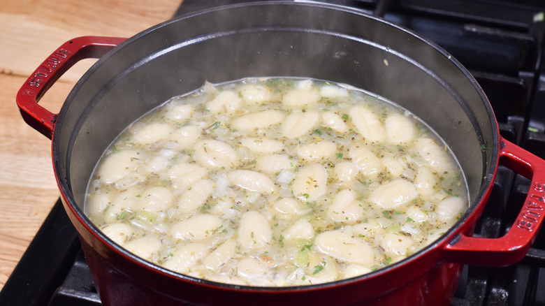 gnocchi floating in soup pot