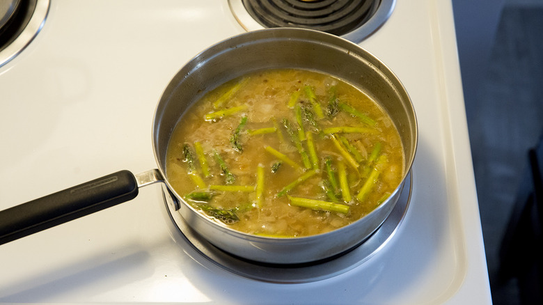 asparagus cooking in garlic sauce