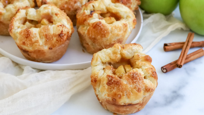 apple-filled pastries with cinnamon sticks and apples