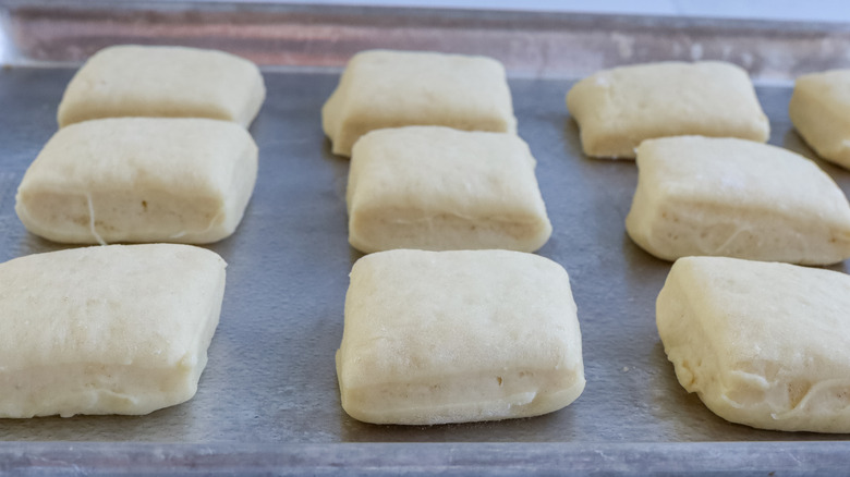 Risen roll dough on a baking sheet