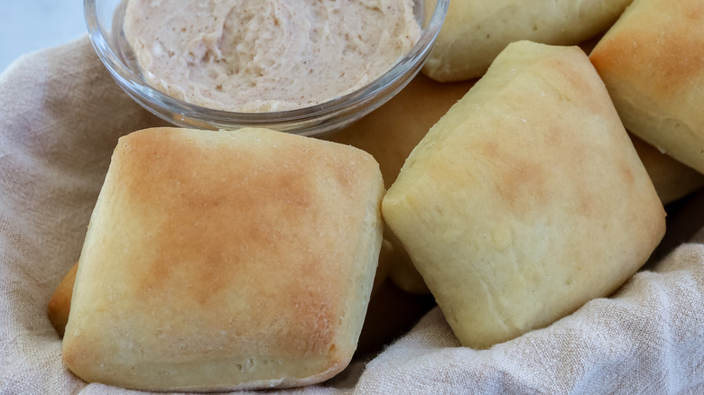 Copycat Texas Roadhouse rolls with cinnamon butter in a basket