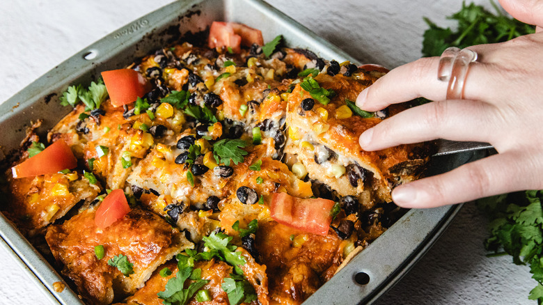 Hand lifting slice of casserole