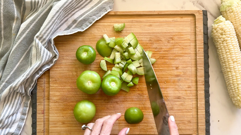 cut tomatillos on cutting board