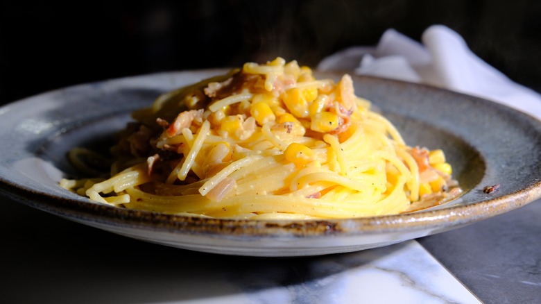 corn spaghetti carbonara in ceramic bowl