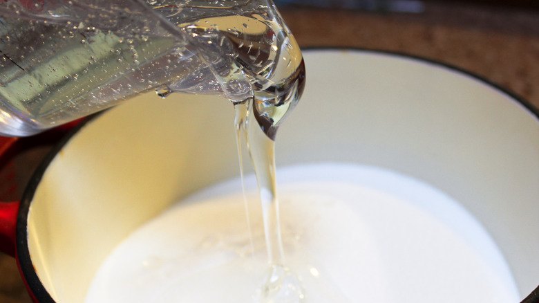 Pouring corn syrup into pan