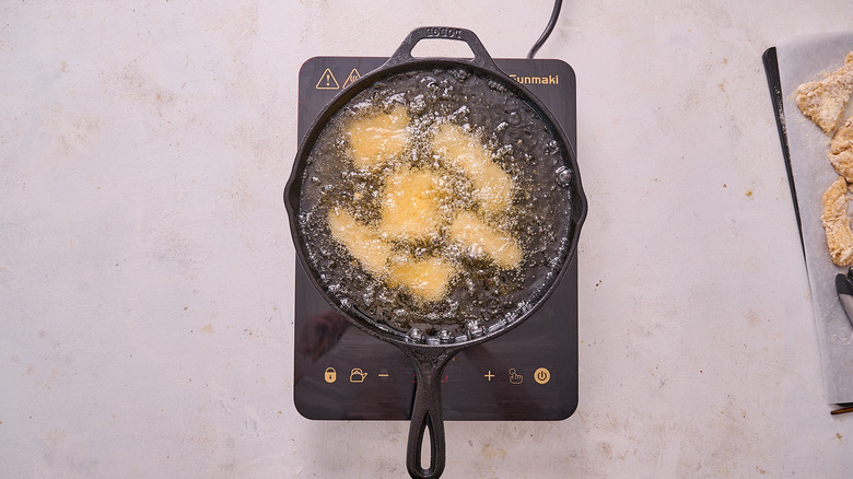 frying catfish in skillet