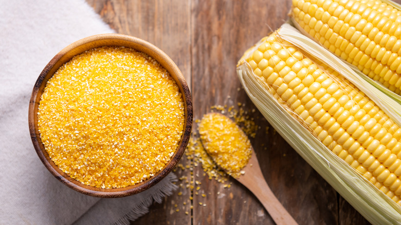 cornmeal in a bowl beside corn