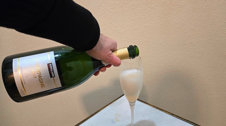 Pouring a glass of Kirkland Signature Champagne