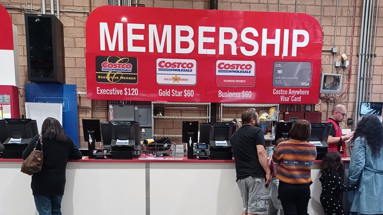 People standing in front of a Costco membership desk