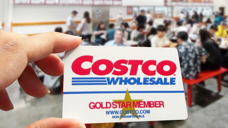 Costco membership card between fingers