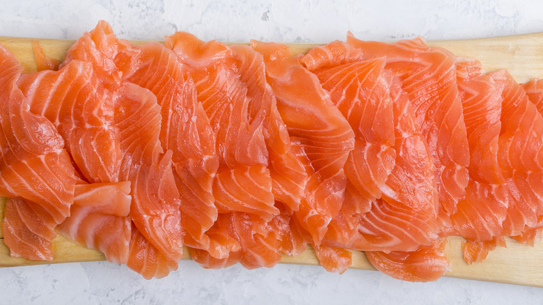 smoked salmon on wood cutting board