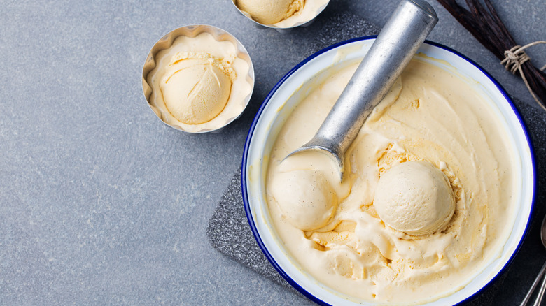 vanilla ice cream in a bowl with scooper