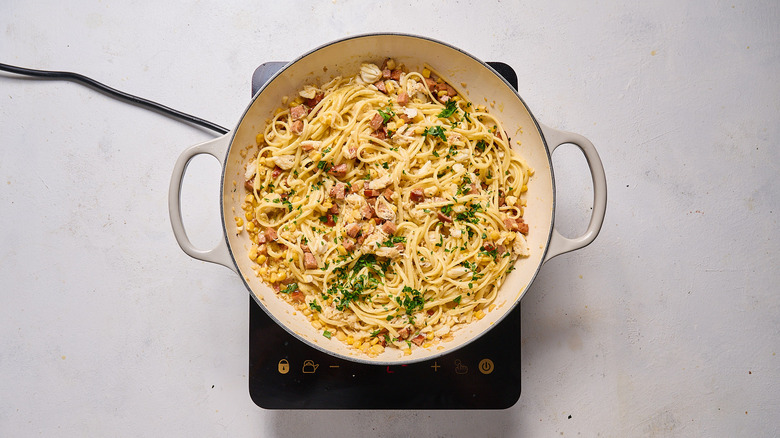 pasta with sausage and crab in pan