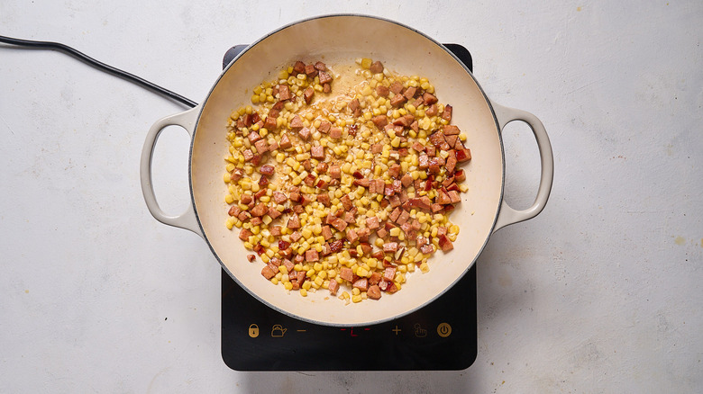 corn and sausage cooking in skillet