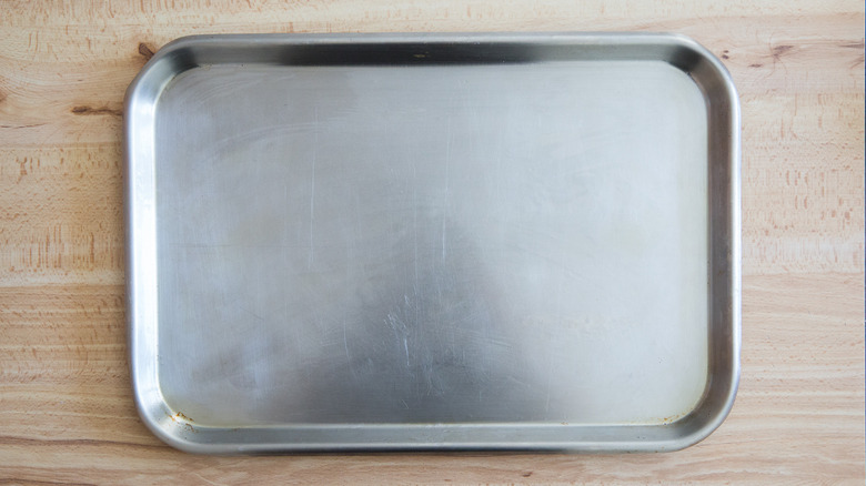 greased baking sheet on table