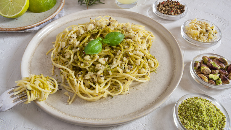 A plate of pasta with pistachio and pesto
