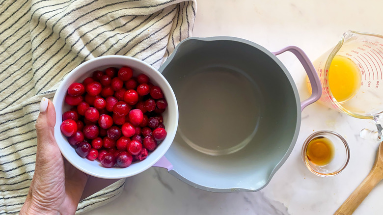 adding cranberries to pot